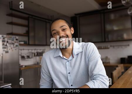 Portrait of smiling biracial man talk on video call Stock Photo