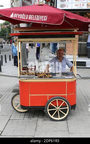 ISTANBUL,TURKEY-JUNE 7:Man selling Roasted Chestnuts  at Istiklal Street.June 7,2015 in Istanbul,Turkey. Stock Photo