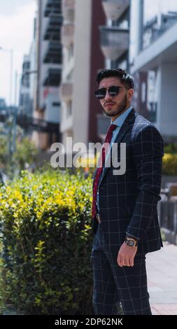 Young business man walking through the city Stock Photo