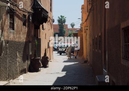 Marrakech, Morocco - February 16 2020: Two women walking and carrying clothes in the streets of Marrakech. Stock Photo