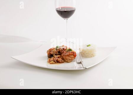 roasted chicken with chopped chestnuts sauce and rice timbale on a white plate . selective focus Stock Photo