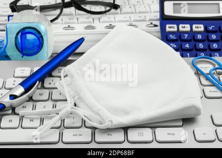 Wear mask and office with pc keyboard Stock Photo