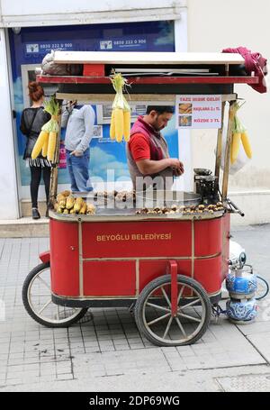 ISTANBUL,TURKEY-JUNE 7:Guy selling Roasted Chestnuts and Corns at Istiklal Street.June 7,2015 in Istanbul,Turkey. Stock Photo