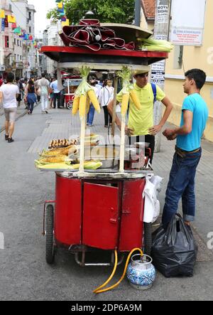 ISTANBUL,TURKEY-JUNE 7:Guy selling Roasted Chestnuts and Corns at Istiklal Street.June 7,2015 in Istanbul,Turkey. Stock Photo