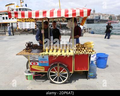 ISTANBUL,TURKEY-JUNE 7:Man selling Roasted Chestnuts and Corns at Eminonu.June 7,2015 in Istanbul,Turkey. Stock Photo