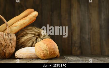 Template with fresh bread and french baguette on a wooden wall background Stock Photo