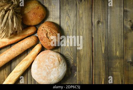 Different fresh bread on a wooden table Stock Photo