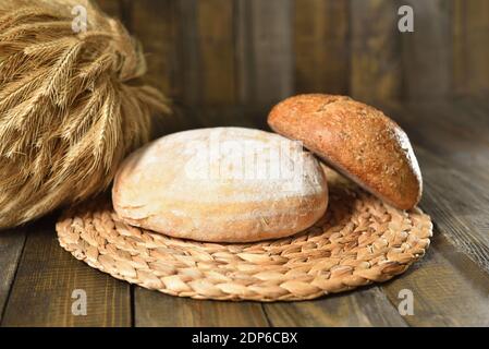 Fresh round breads on a wooden table Stock Photo