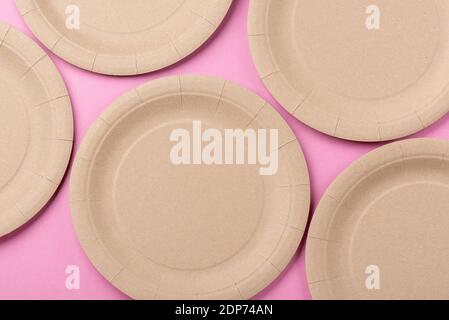 Eco-friendly biodegradable paper dishes on a pink background Stock Photo