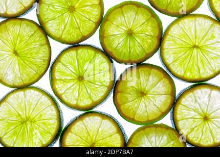 Green lime slices isolated on a white background with top view and structure. Healthy vegan food. Stock Photo