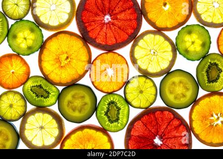 Collage of various fruit slices grapefruit, orange, manderin, lemon, lime, kiwi and vegetables cucumber and zucchine isolated on a white background wi Stock Photo