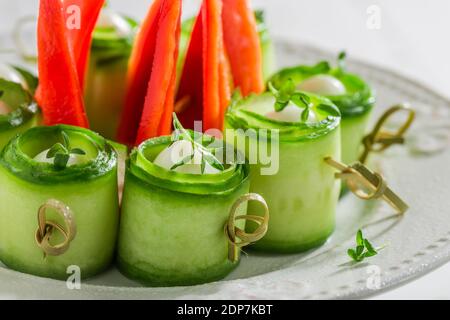 Closeup of fresh cold snacks made of vegetables and eggs on white plate Stock Photo