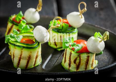 Delicious unique finger food made of fresh ingredients for party on black table Stock Photo