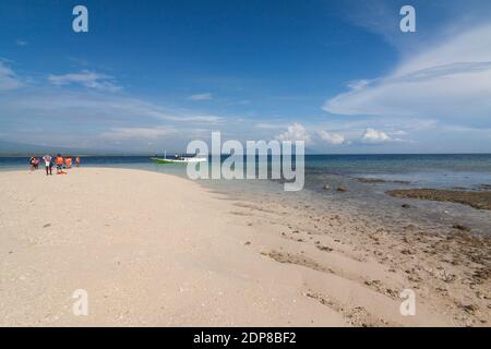 The tourists arrive at Tabuhan Island, one of the marine tourism destinations in Banyuwangi district. Stock Photo