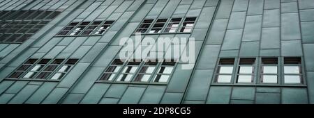 A section of the green exterior facade of a small generic building Stock Photo