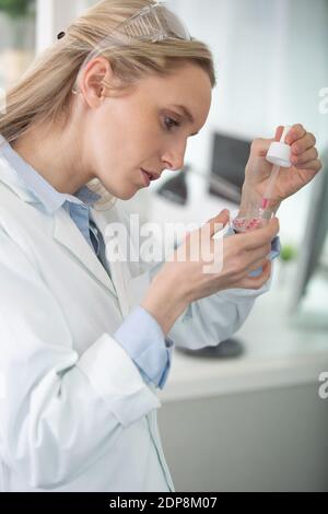 young female scientist loads samples for dna Stock Photo