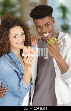 a couple eating different food Stock Photo