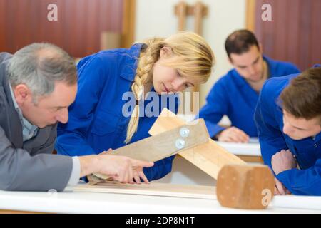 focused young people making furniture in carpenters workshop Stock Photo