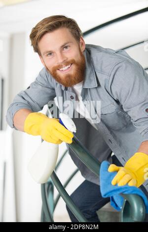male janitor cleaning staircase with mop Stock Photo