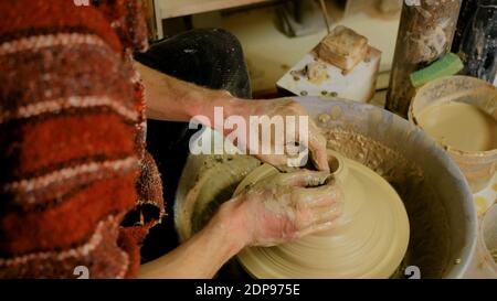 Professional male potter making mug in pottery workshop Stock Photo - Alamy