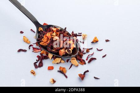 Fruit tea leaves in spoon on white background Stock Photo