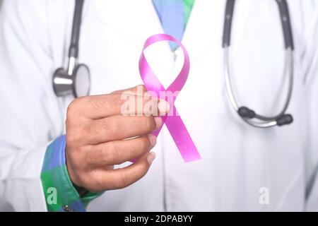 hand holding pink color HIV ribbon close up  Stock Photo