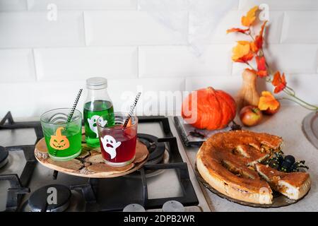 happy Halloween with pumpkin pie and drinks in the kitchen Stock Photo