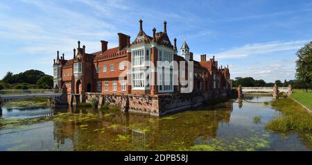 Helmingham Hall with moat bridges and reflections. Stock Photo