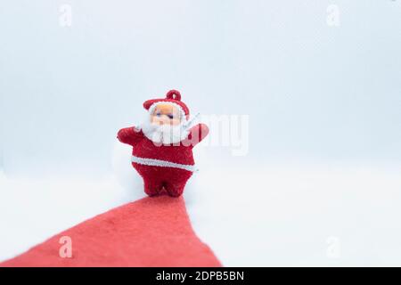 Santa Claus standing on the red carpet on a white backgrounds Stock Photo
