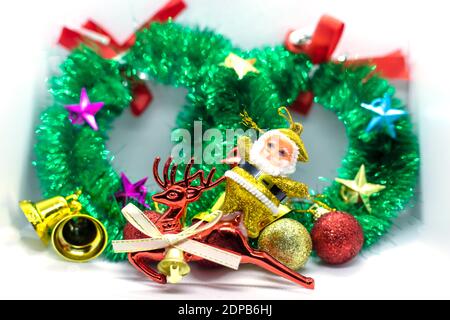 Santa on a reindeer with a Christmas wreath decorated with ornaments backgrounds Stock Photo
