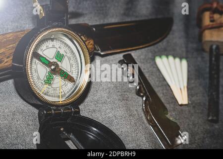 Compass, knife and matches. EDC. Wearable set for survival and tourism. Stock Photo