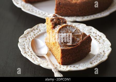 fresh baked delicious chocolate and walnuts cake with slice of orance on top Stock Photo