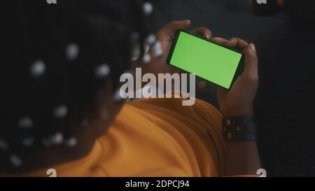 Black man speaking with someone using smart phone with green screen. High quality photo Stock Photo