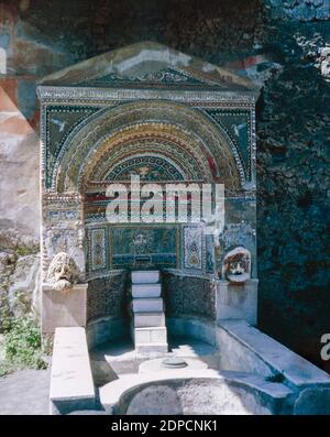 Archive scan of ruins of Pompeii comune destroyed by eruption of Mount Vesuvius in AD 79.  Household altar of the Great Fountain. May 1968. Stock Photo