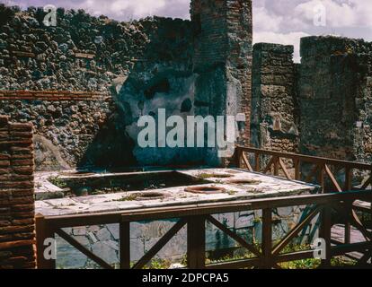 Archive scan of ruins of Pompeii comune destroyed by eruption of Mount Vesuvius in AD 79.  Corner shop ruins. May 1968. Stock Photo