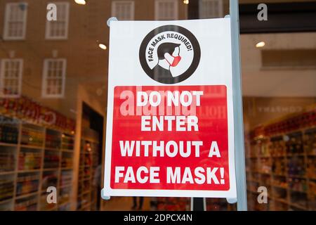 Windsor, Berkshire, UK. 2 November, 2020. A face mask required sign in the window at a new American Candy shop that has opened in Windsor. Shoppers were out in Windsor today buying Christmas presents and provisions before England goes back into a Covid-19 lockdown again from Thursday 5th November. Another 202 cases of Coronavirus were recorded in Berkshire in figures released yesterday. The Royal Borough of Windsor and Maidenhead now has 1,543 positive cases up 36 on the day before. Credit: Maureen McLean/Alamy Stock Photo