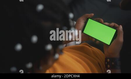 African american black man holding smartphone with green screen and nodding his head. High quality photo Stock Photo