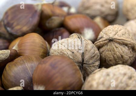 In the foreground the chestnuts and walnuts, typical fruit of the Christmas period Stock Photo