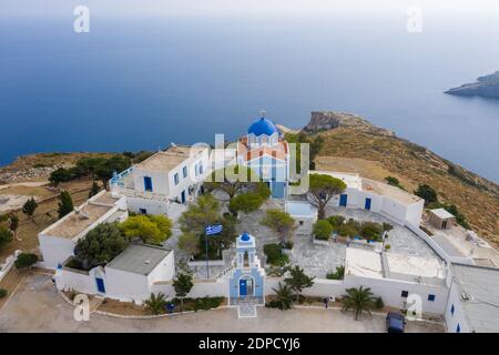 Greece. Kea island, Kastriani monastery, blue sea background. Aerial drone view of church and whitewashed buildings Stock Photo