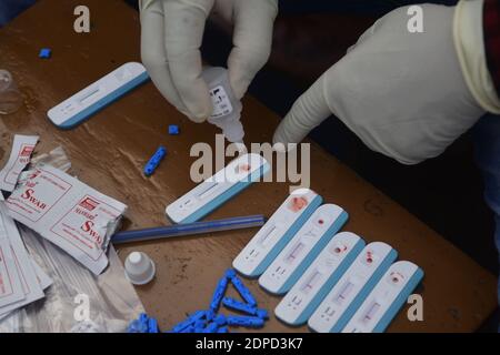 Health workers are testing blood of drivers from different commercial vehicles at a bus stand during a counselling and HIV test camp, organised by the Tripura State AIDS Control society.  Agartala, Tripura, India. Stock Photo