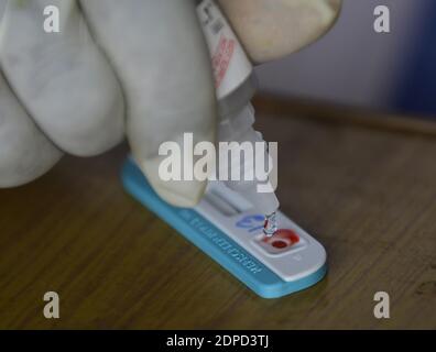 Health workers are testing blood of drivers from different commercial vehicles at a bus stand during a counselling and HIV test camp, organised by the Tripura State AIDS Control society.  Agartala, Tripura, India. Stock Photo