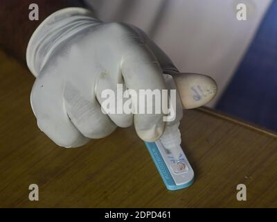 Health workers are testing blood of drivers from different commercial vehicles at a bus stand during a counselling and HIV test camp, organised by the Tripura State AIDS Control society.  Agartala, Tripura, India. Stock Photo