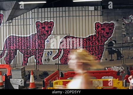 GREAT BRITAIN / London/ Street Art /A woman walks past a  graffiti artwork /A subway painted by stencil artists at a giant new exhibition space create Stock Photo