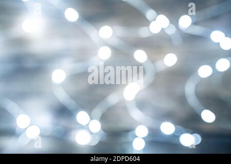 Burning lights garland on a wooden background. Side view. Stock Photo