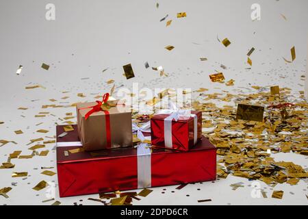 two little and one big boxes with an interesting gifts in a beautiful pack isolated on white background Stock Photo