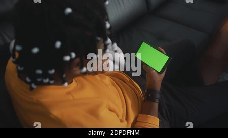 African american black man holding smartphone with green screen. High quality photo Stock Photo