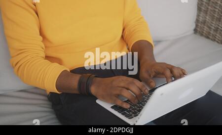 Close up, black man using laptop. Remote work or distance education concept. High quality photo Stock Photo
