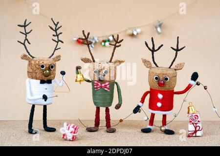 Festive Christmas decoration made of champagne cork with celebrating deers and instruments Stock Photo