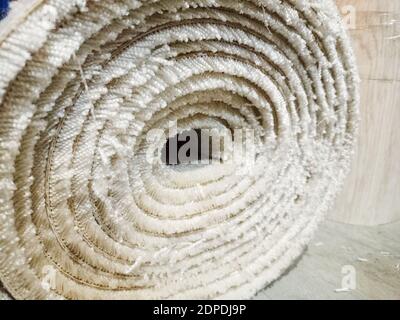 Close-up of a roll of carpet without a stitched edge.  Stock Photo