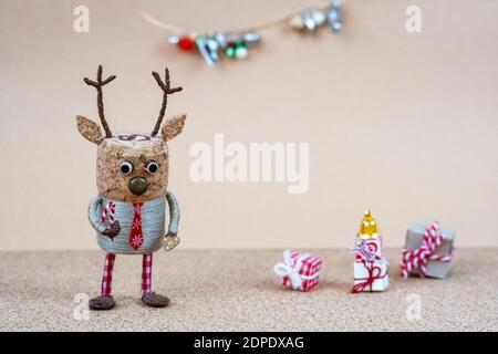Deer made of champagne cork celebrating Christmas on corkwood texture, handmade decoration with Scandinavian elements Stock Photo